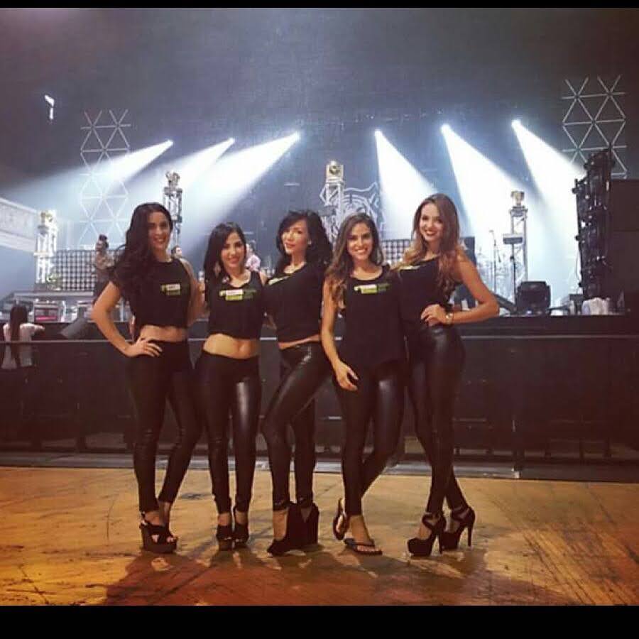 Professional promotional team on concert stage with dramatic lighting