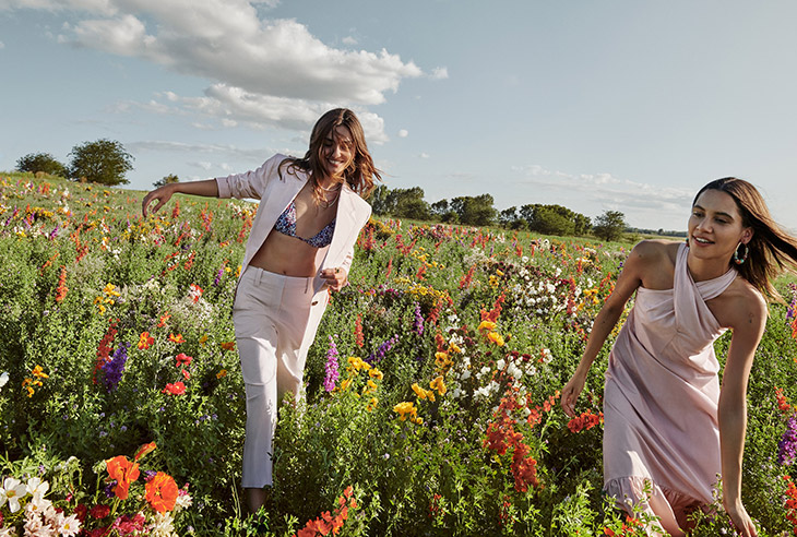 Mango Life in Bloom campaign duo shot with two models playing in wildflower field
