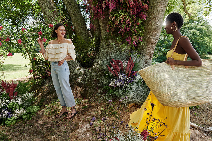Mango Life in Bloom campaign garden scene with two models in natural outdoor setting