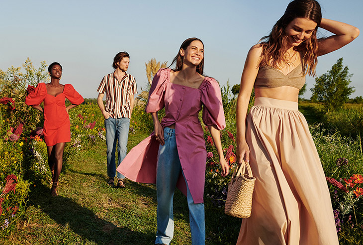 Mango Life in Bloom campaign group shot with four models walking through wildflower field